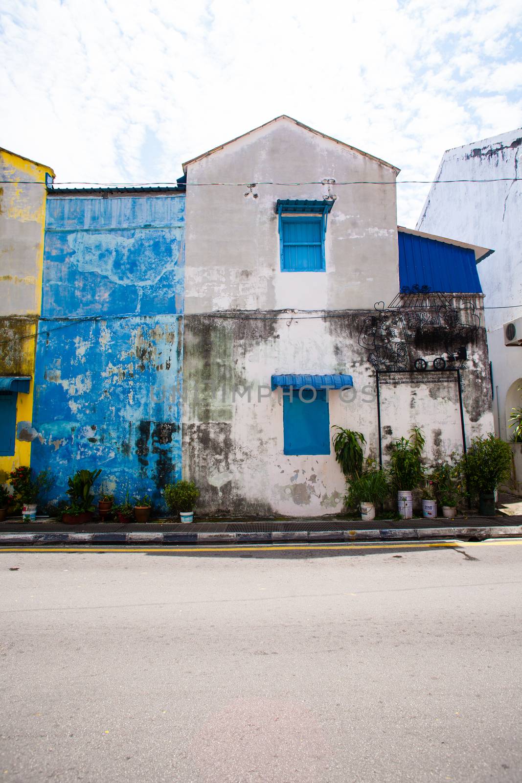 Penang, Malaysia architecture narrow streets. Dirty moldy humidity wall on cityscape