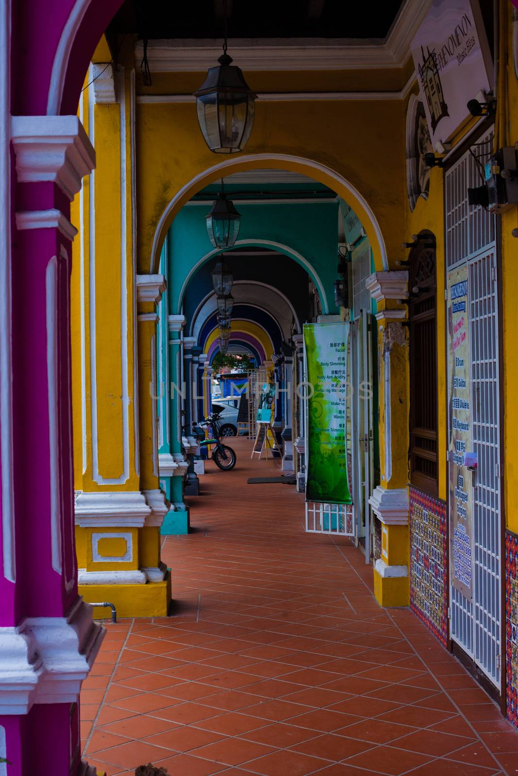 Penang, Malaysia. Color architecture narrow streets with people. Dirty moldy humidity cityscape