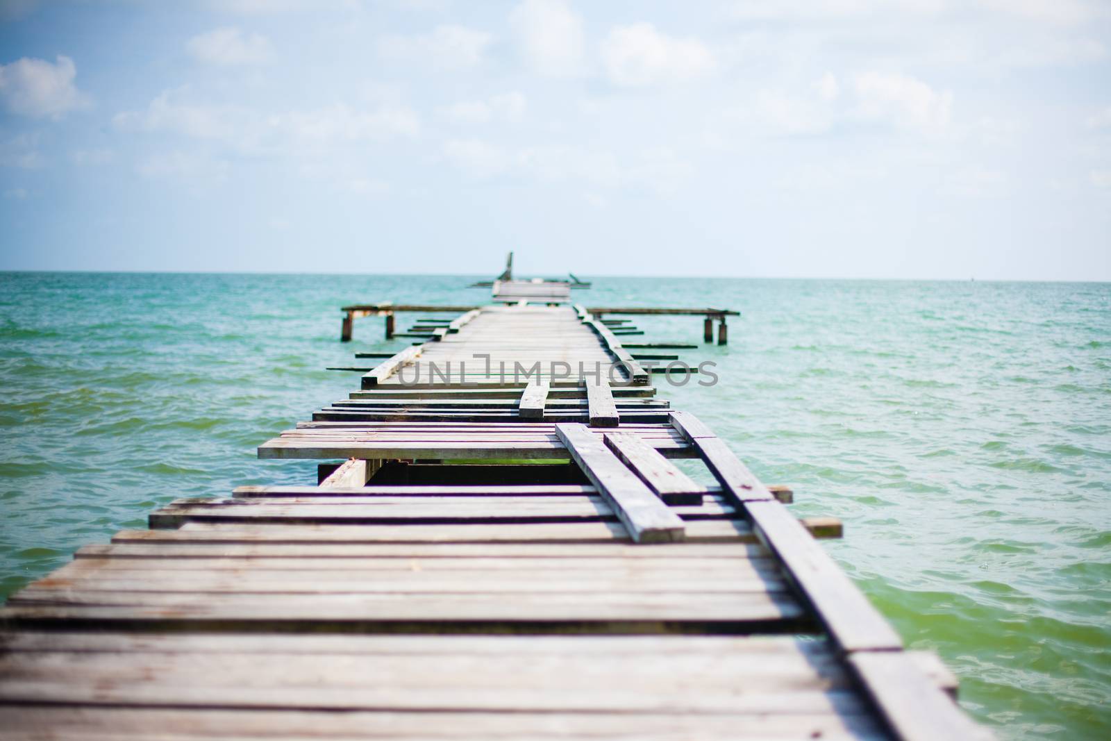 Penang island Malaysia. Wooden pier on the sea background, destroyed bridge near tropics. Color panorama