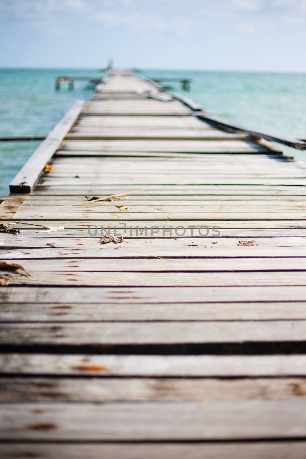 Wooden pier on the sea background by Vanzyst