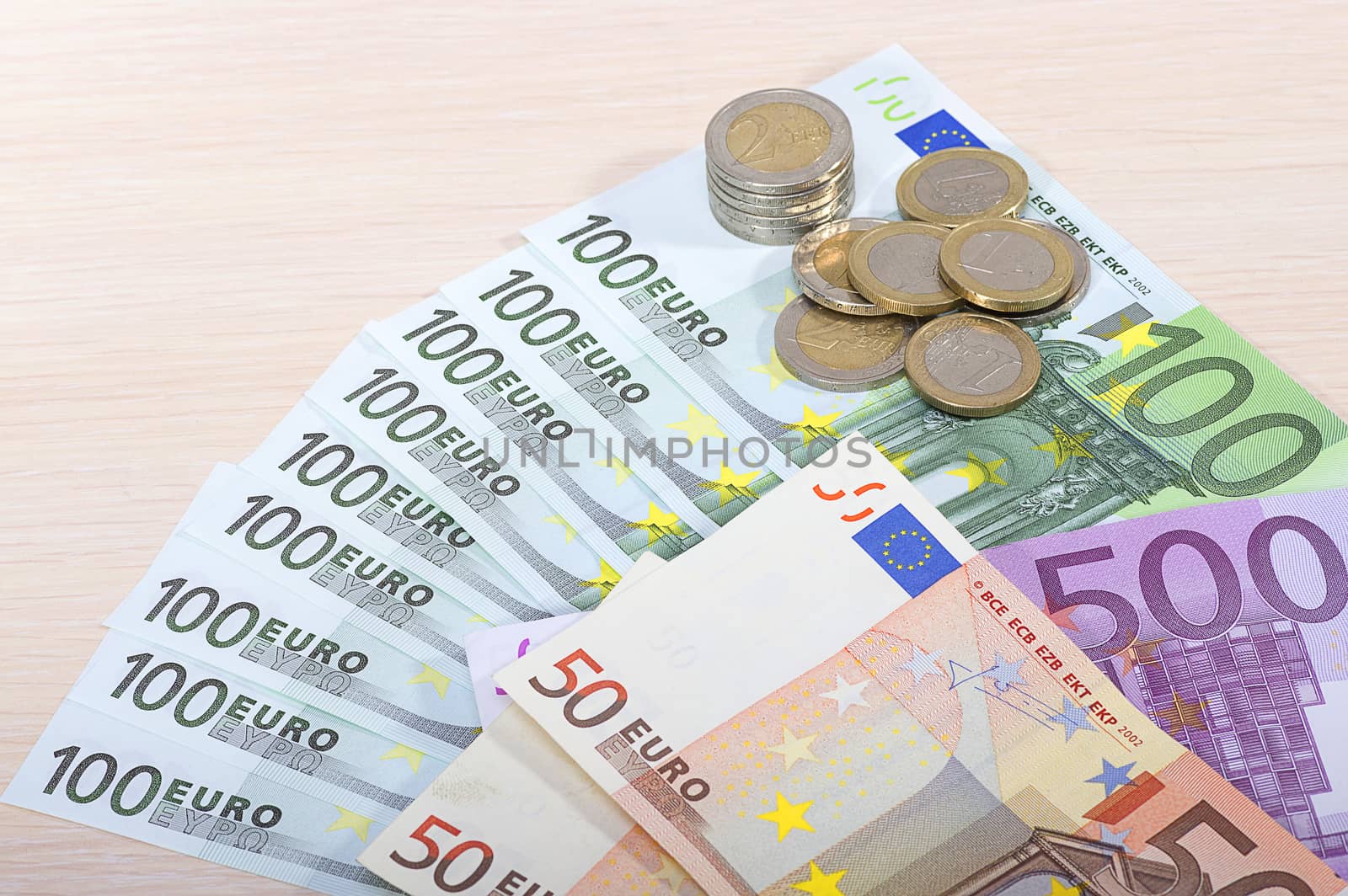 Different money bills and coins lie on the table close-up