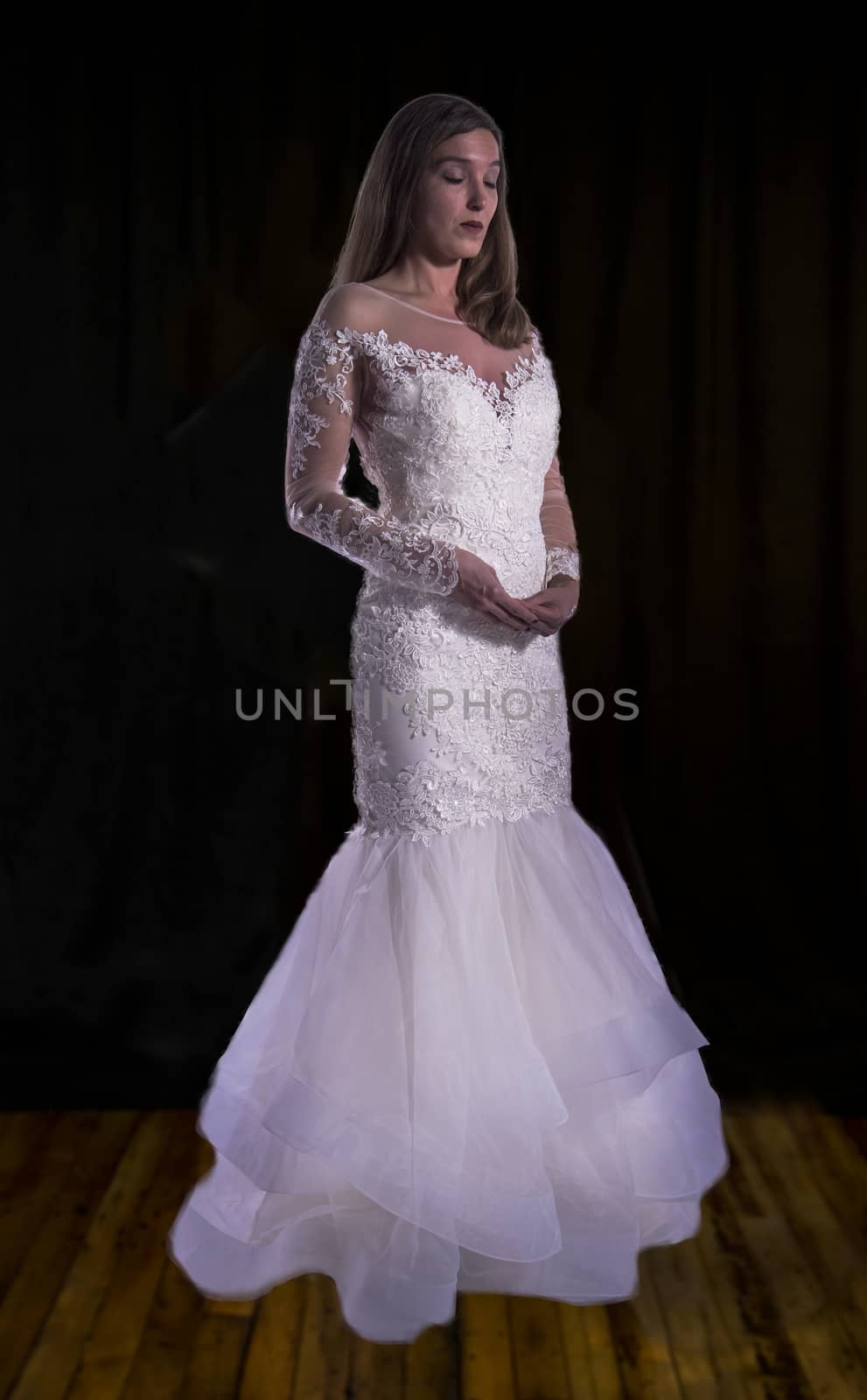 Portrait of a beautiful girl in image of the bride. Photo shot in the Studio on a white background