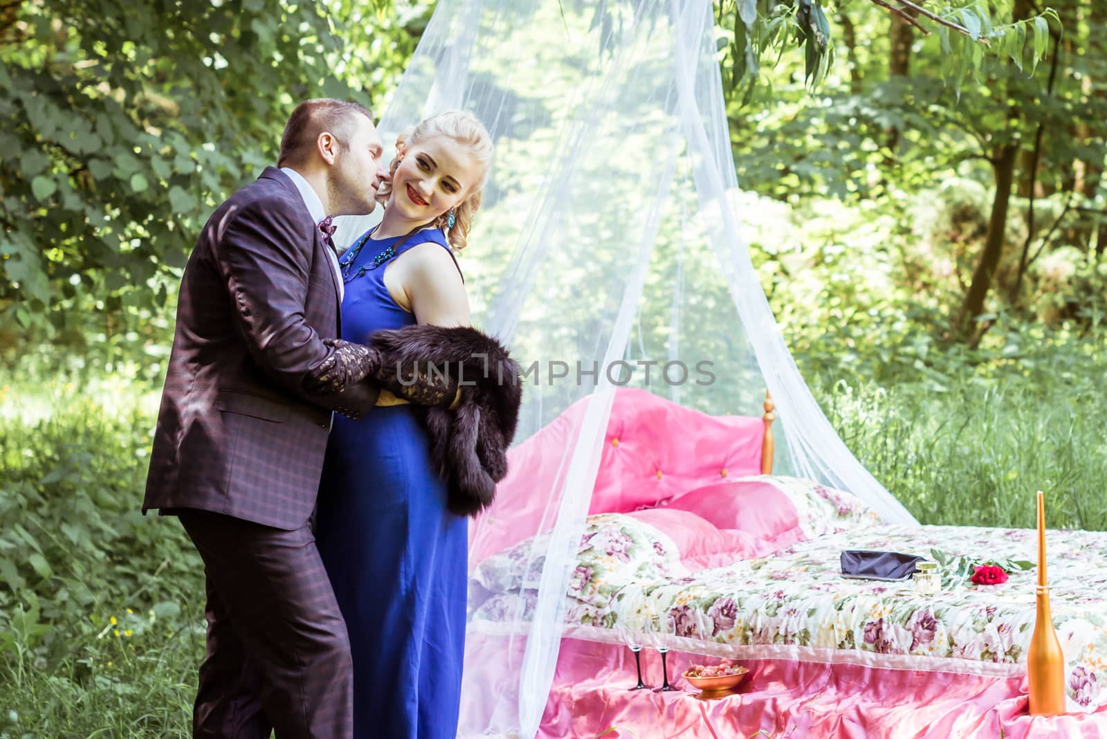 Man and woman standing by the bed and hugging on the lawn in Lviv, Ukraine.