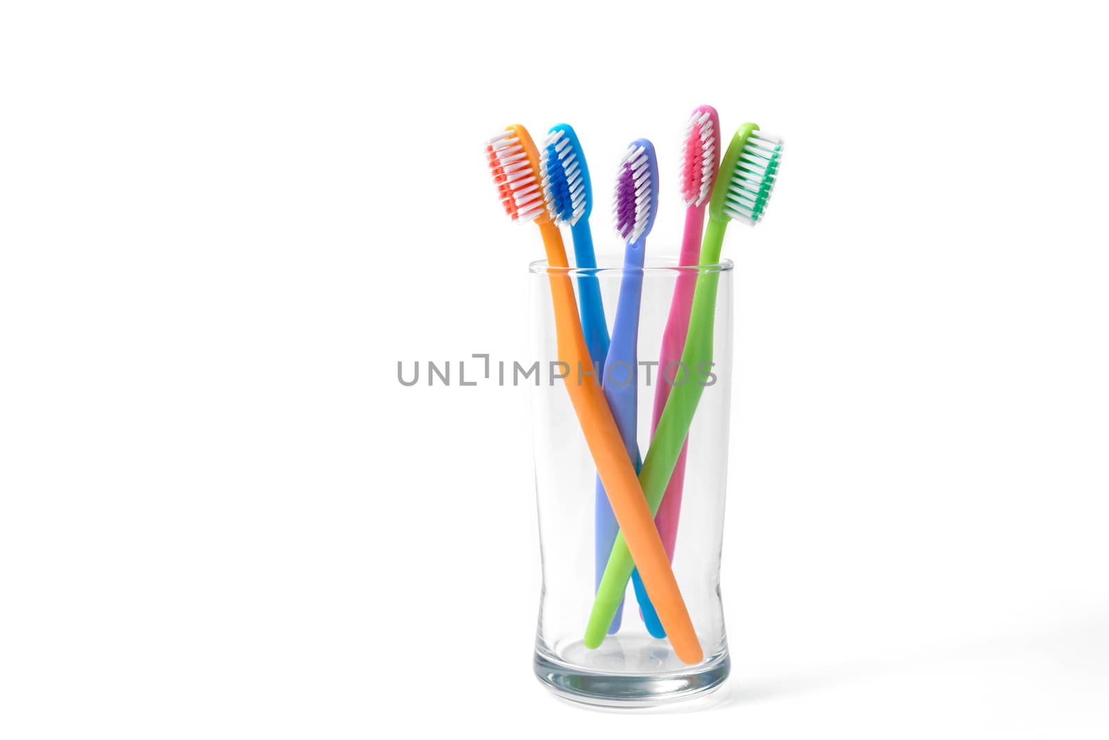 colorful toothbrushes in glass