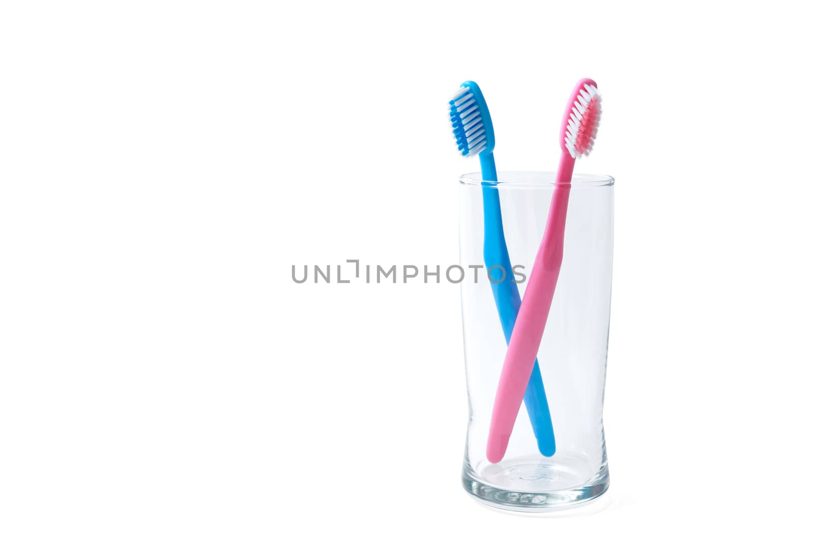 two toothbrushes in glass