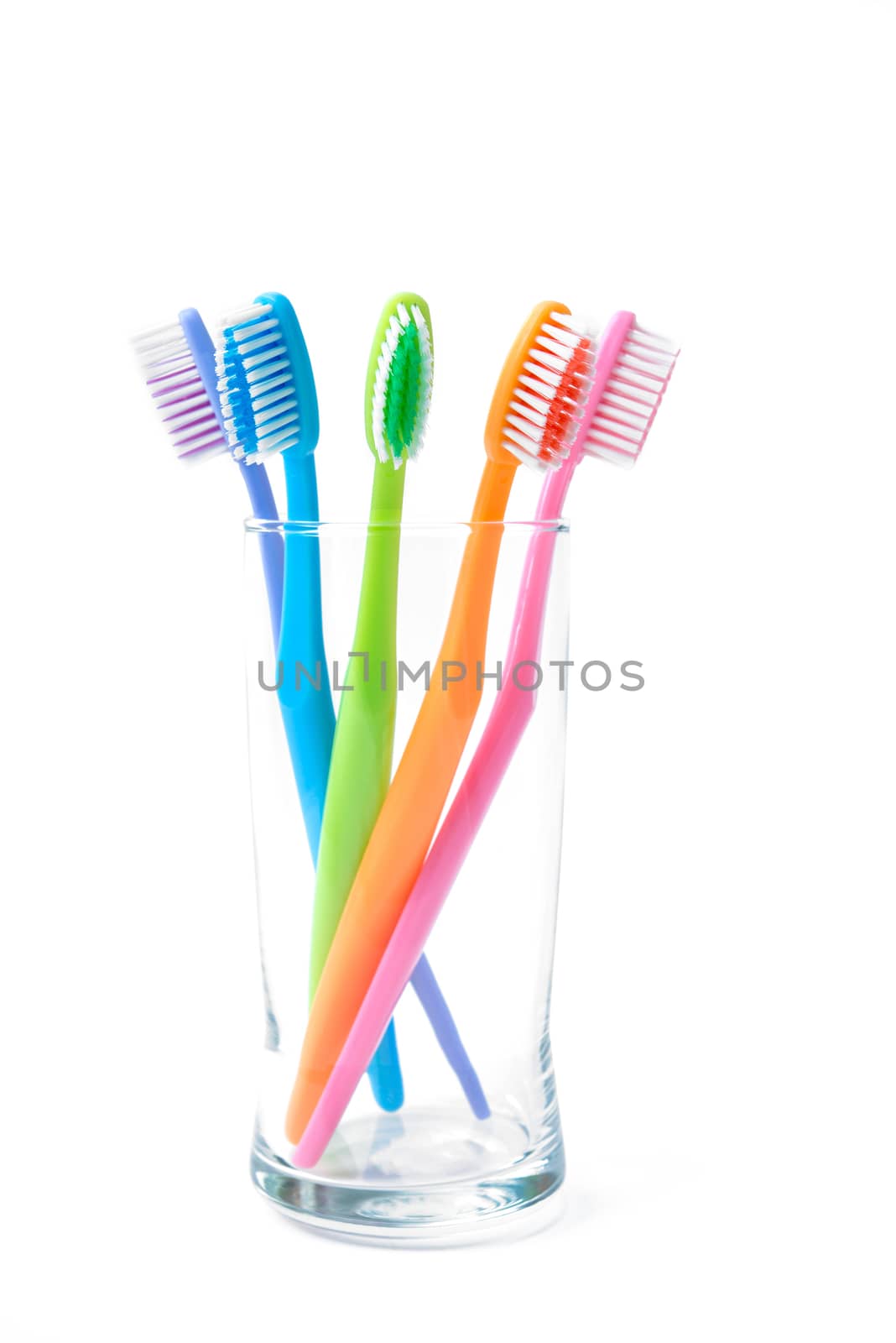 colorful toothbrushes in glass