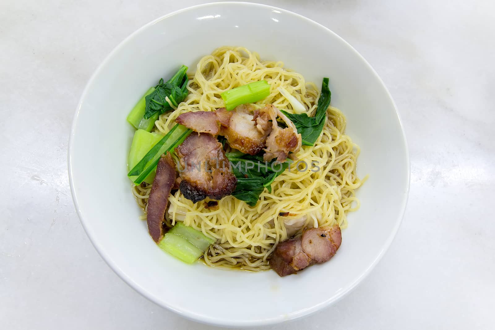 Char Siew Barbecue Pork Wanton Noodles with green vegetable dried version closeup macro