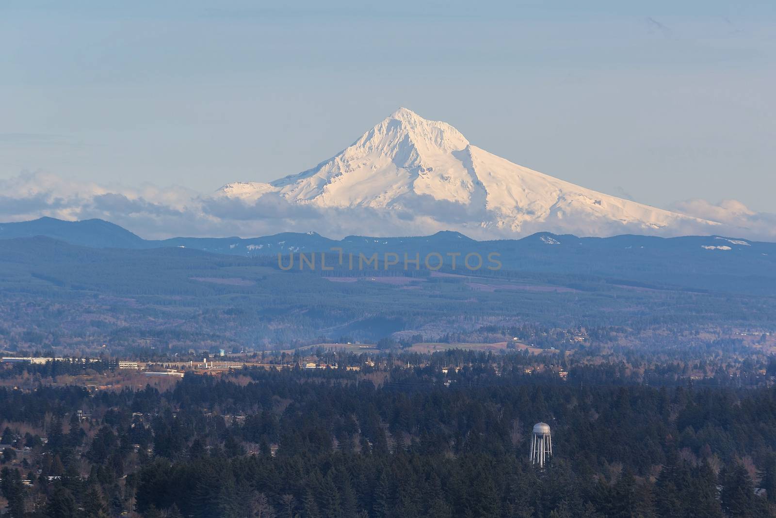Snow covered Mount Hood view with water tower in the landscape on a sunny day