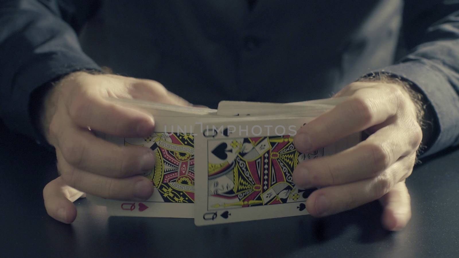 Man's hands shuffing cards. Pocker game by Chudakov
