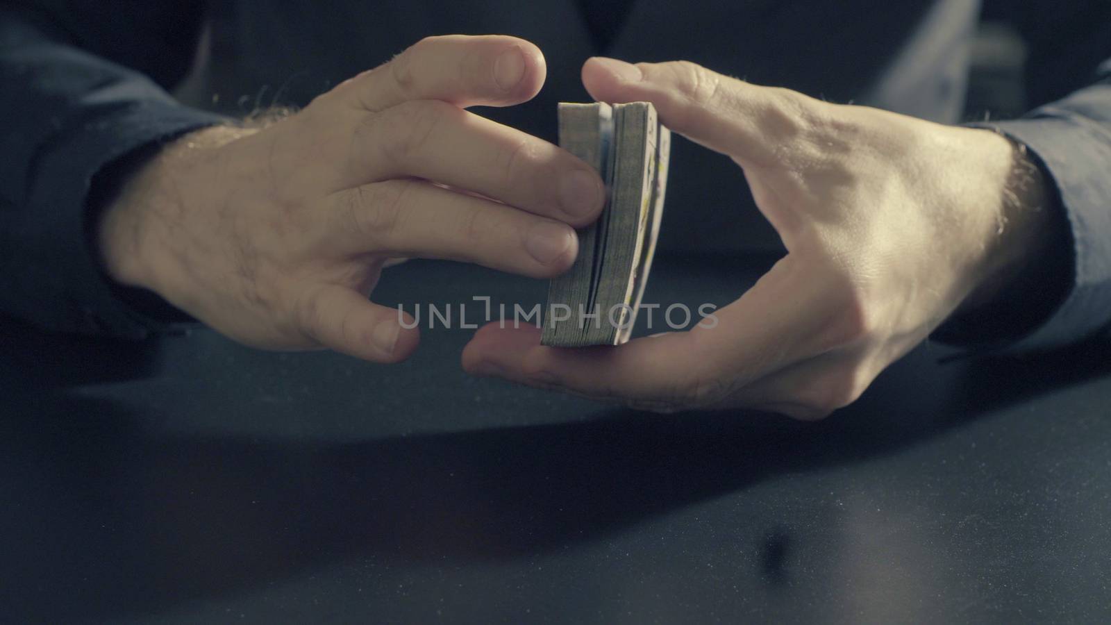 Man's hands shuffing cards. Pocker game by Chudakov