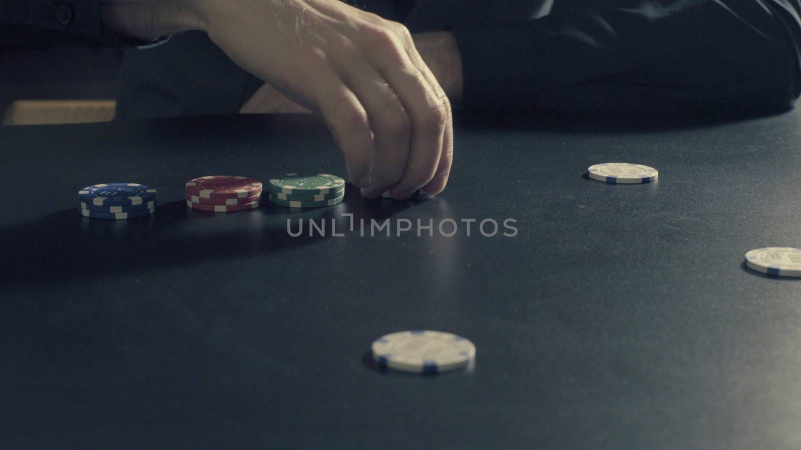 Poker game - dealing cards. Man's hands dealing cards and chips. Close up