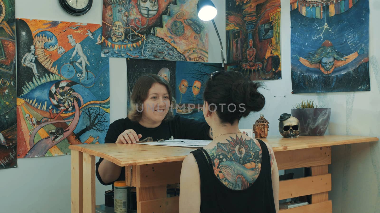 Portrait of two womans in tattoo salon.