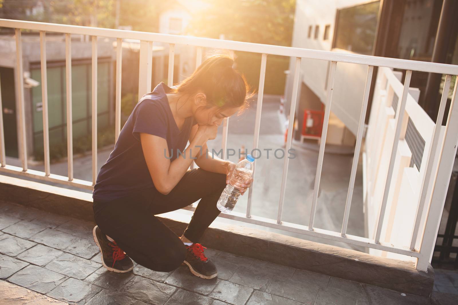 Sports women relax time and drinking water by nopparats