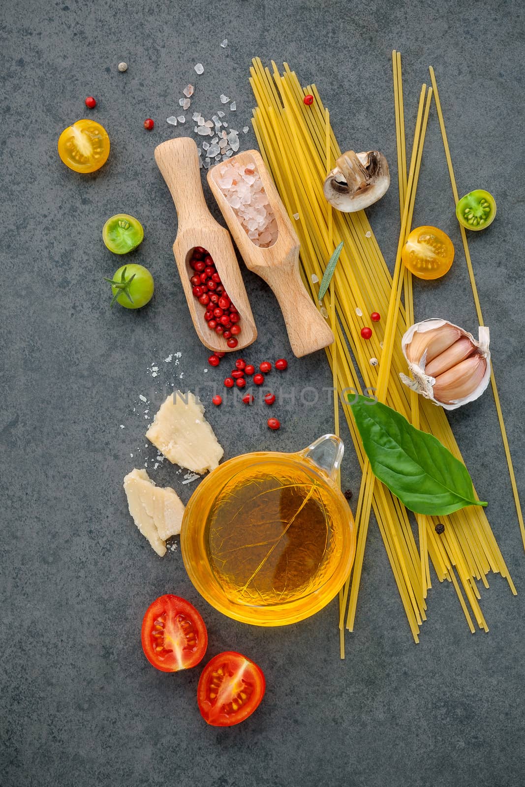 Italian food concept. Spaghetti with ingredients sweet basil ,tomato ,garlic peppercorn ,champignon,zucchini and parmesan cheese on dark background flat lay and copy space.