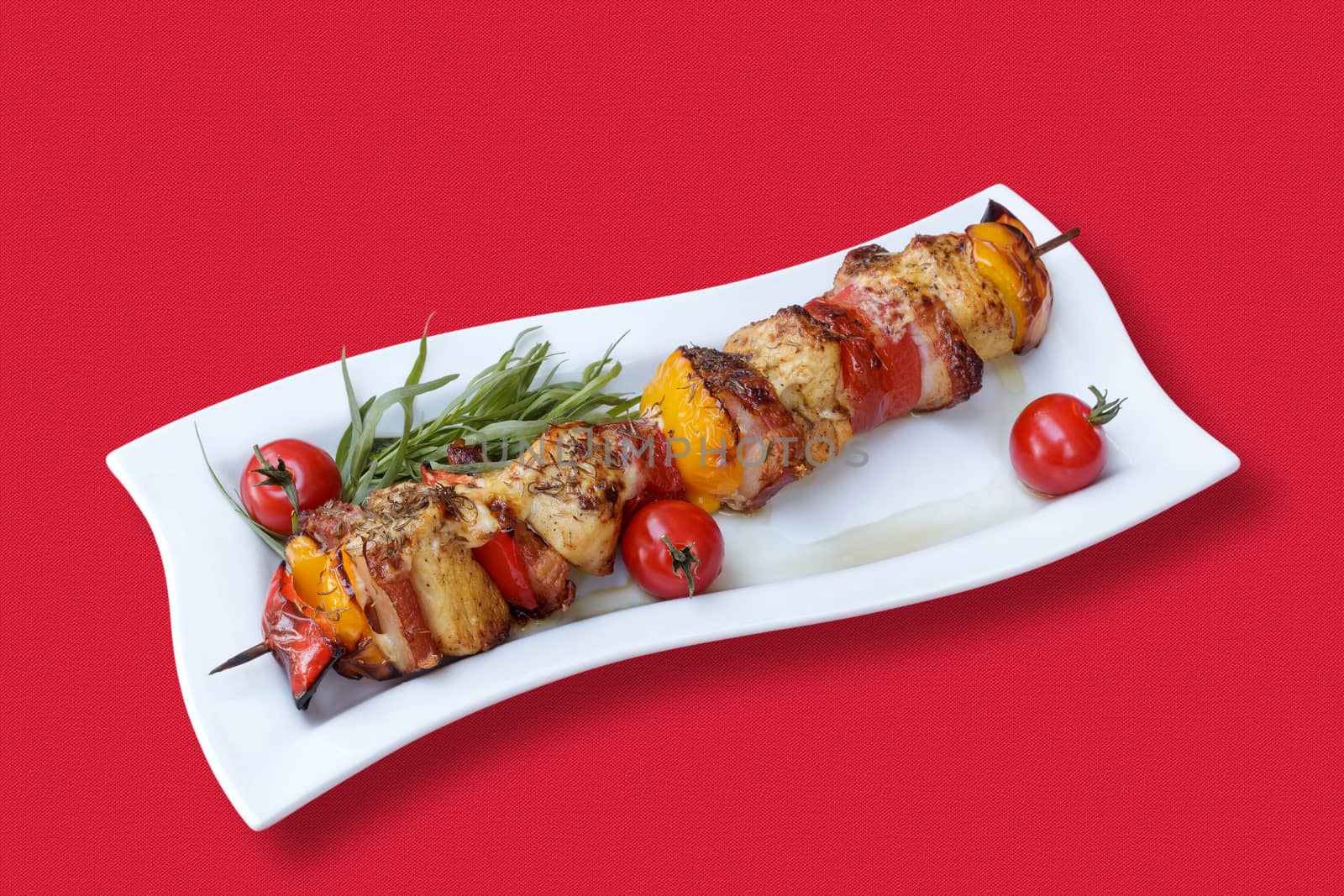 Skewers of meat and vegetables on the grill by fogen
