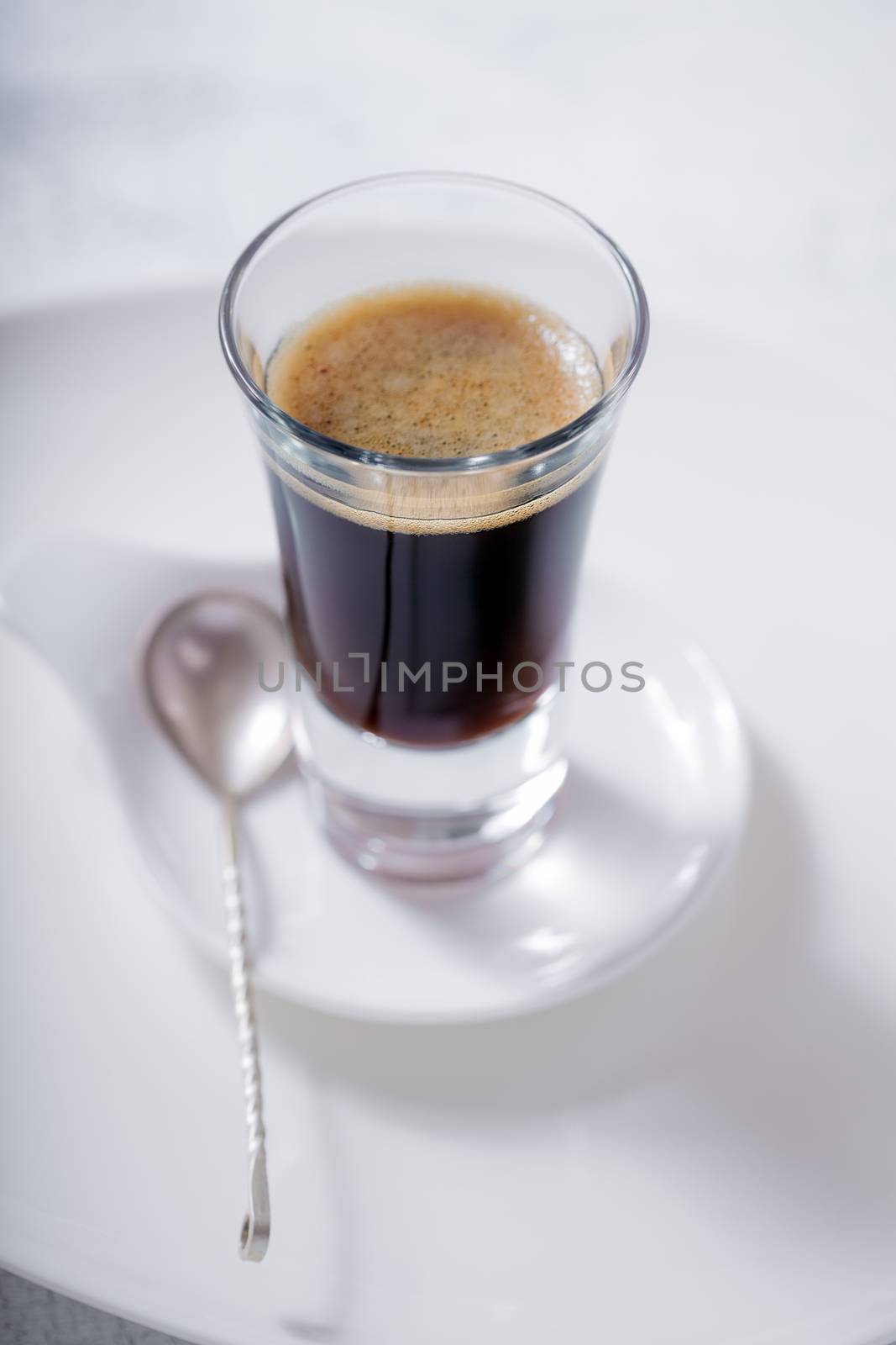 Cup of coffee espresso with a spoon