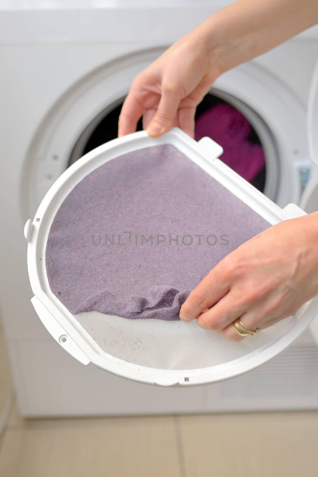 Woman Taking the lent of Dryer Machine