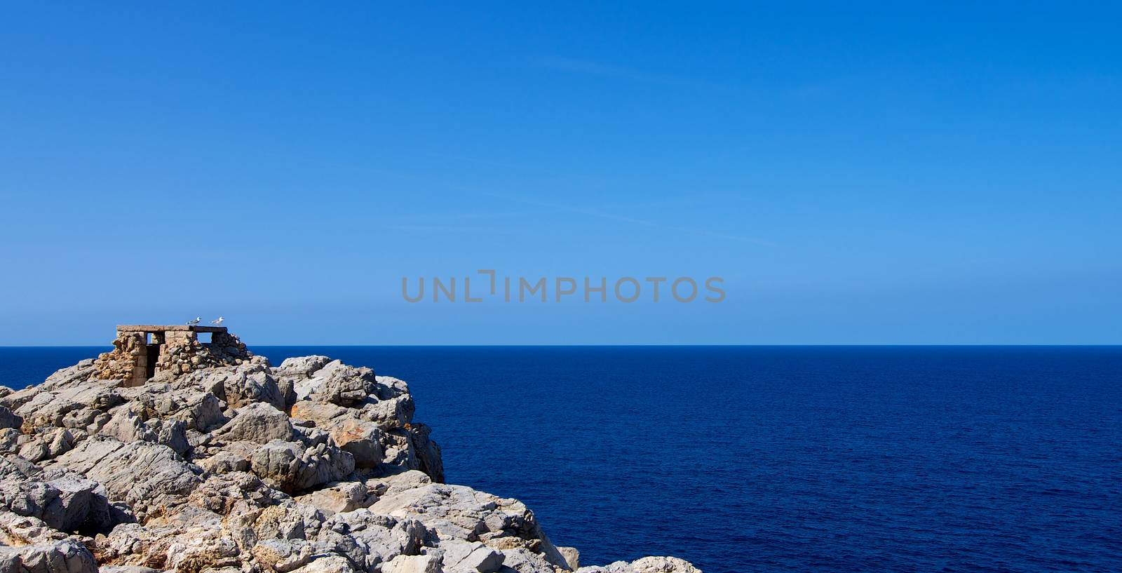 Historical Artillery Facilities near Punta Nati against Blue Sky Outdoors. North West of Menorca, Balearic Islands 