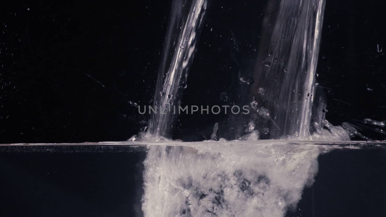 Flowing water on black background by Chudakov