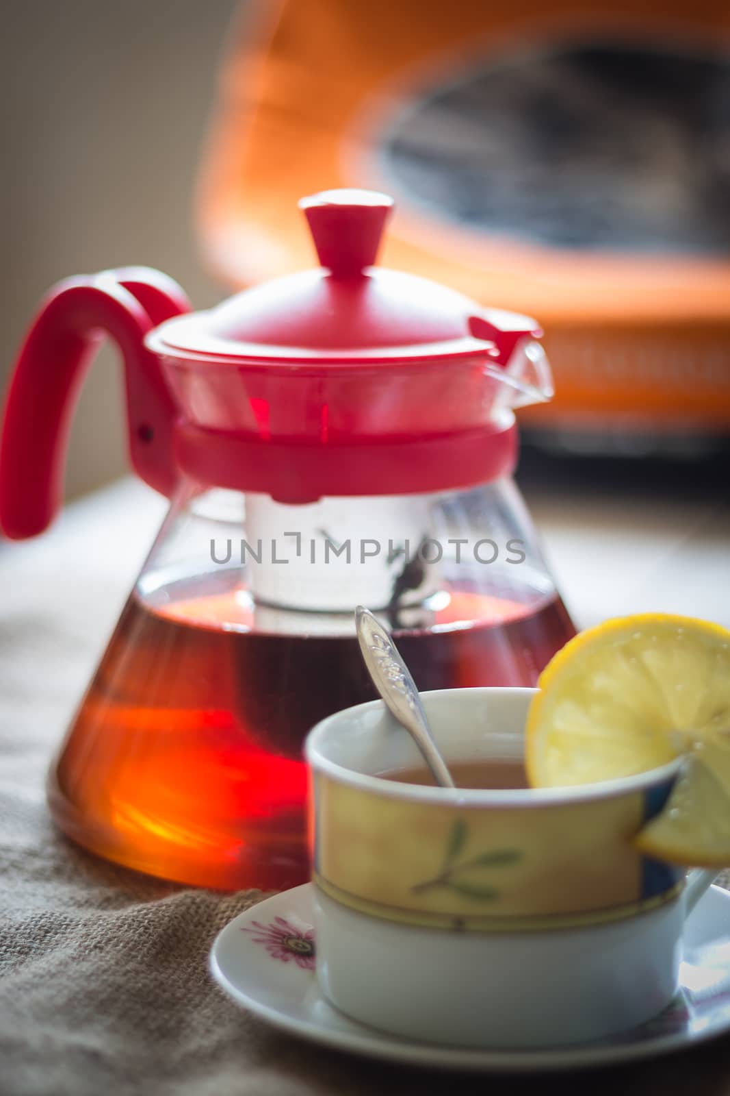 photo blurry view of tea cup with tea kettle