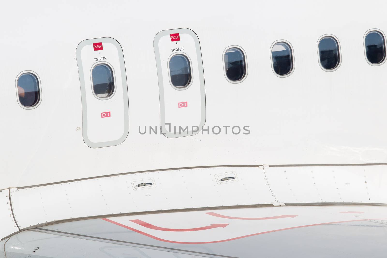 Windows of airplane with emergency exit door