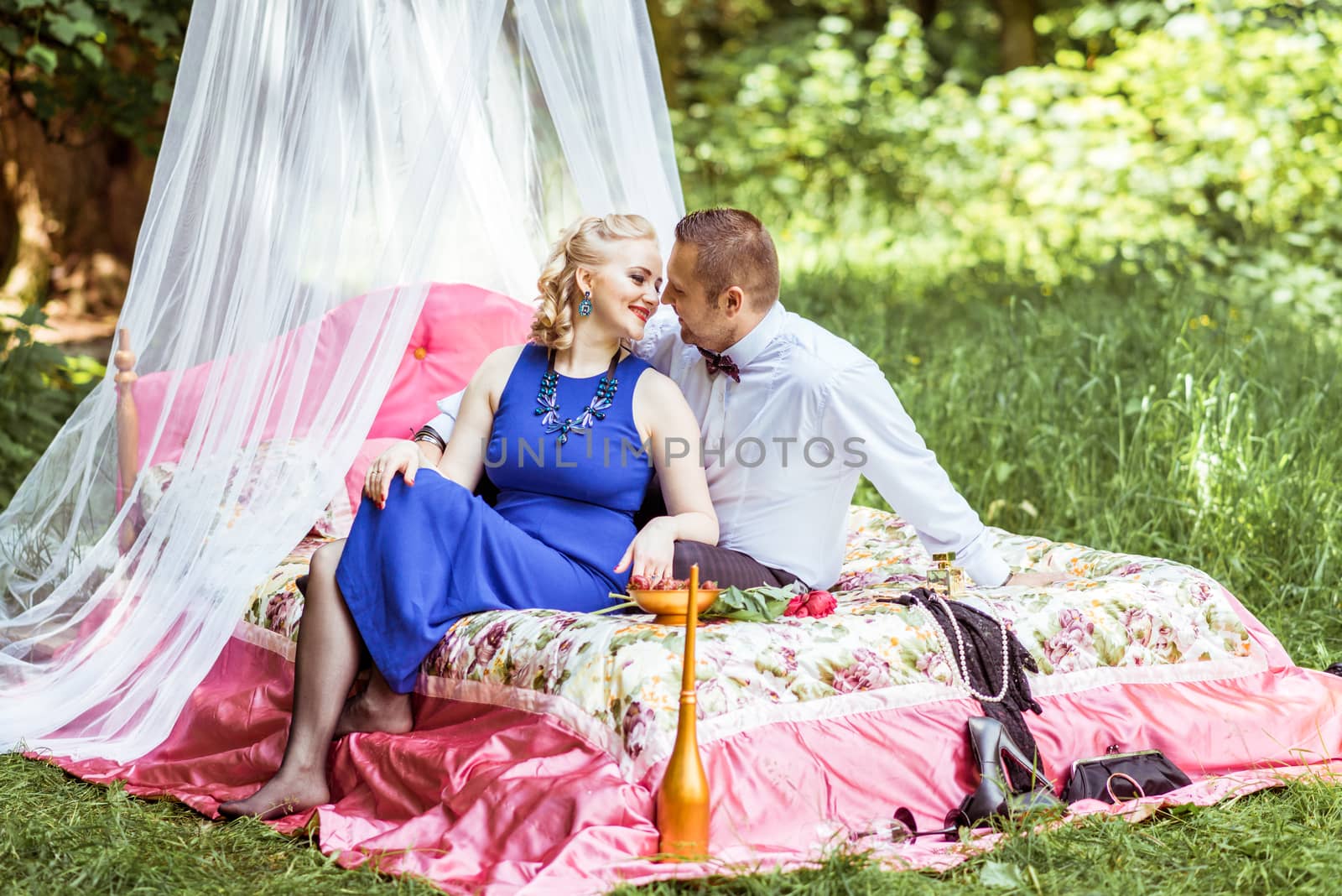 Man and woman sitting on the bed and looking at each other in the lawn in Lviv, Ukraine.
