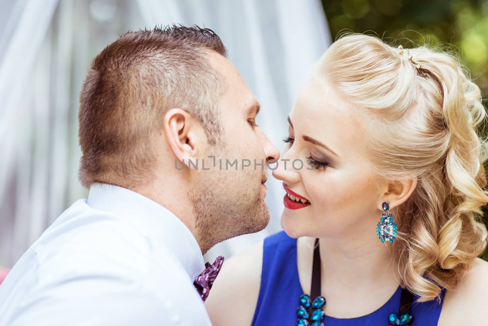 Man and woman sitting on the bed and looking at each other in the lawn in Lviv, Ukraine.