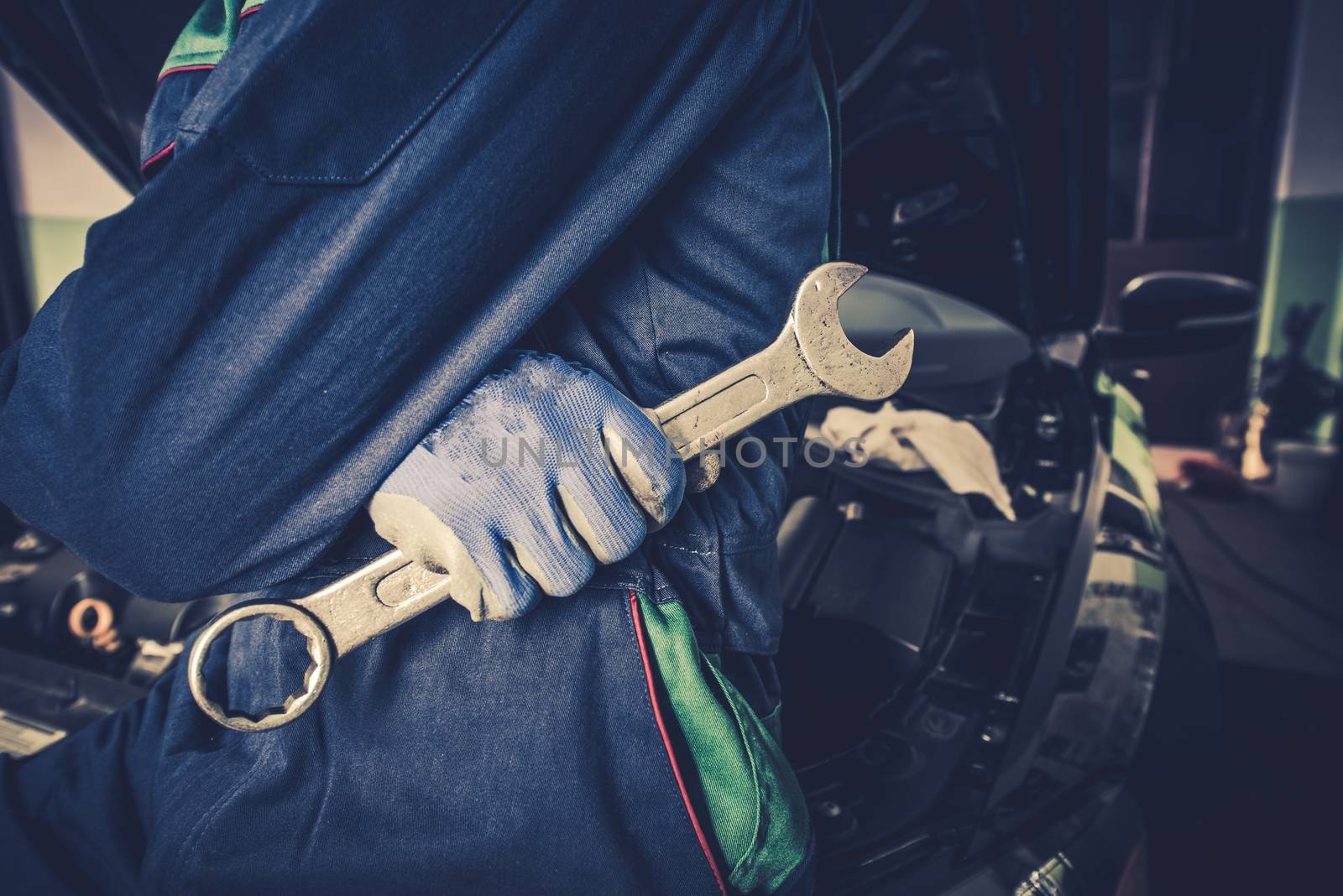 Car Mechanic with Huge Wrench Preparing For Car Maintenance and Big Fix.