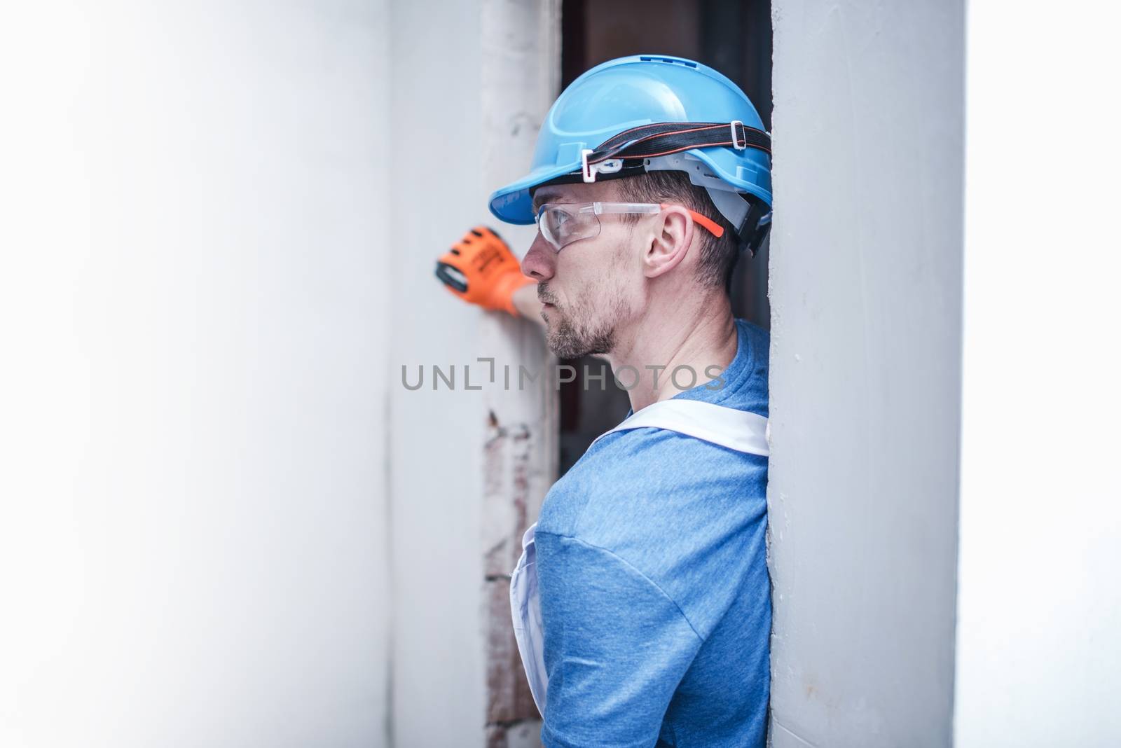 Caucasian Construction Worker Taking a Moment To Rethink His Project and the Current Schedule.