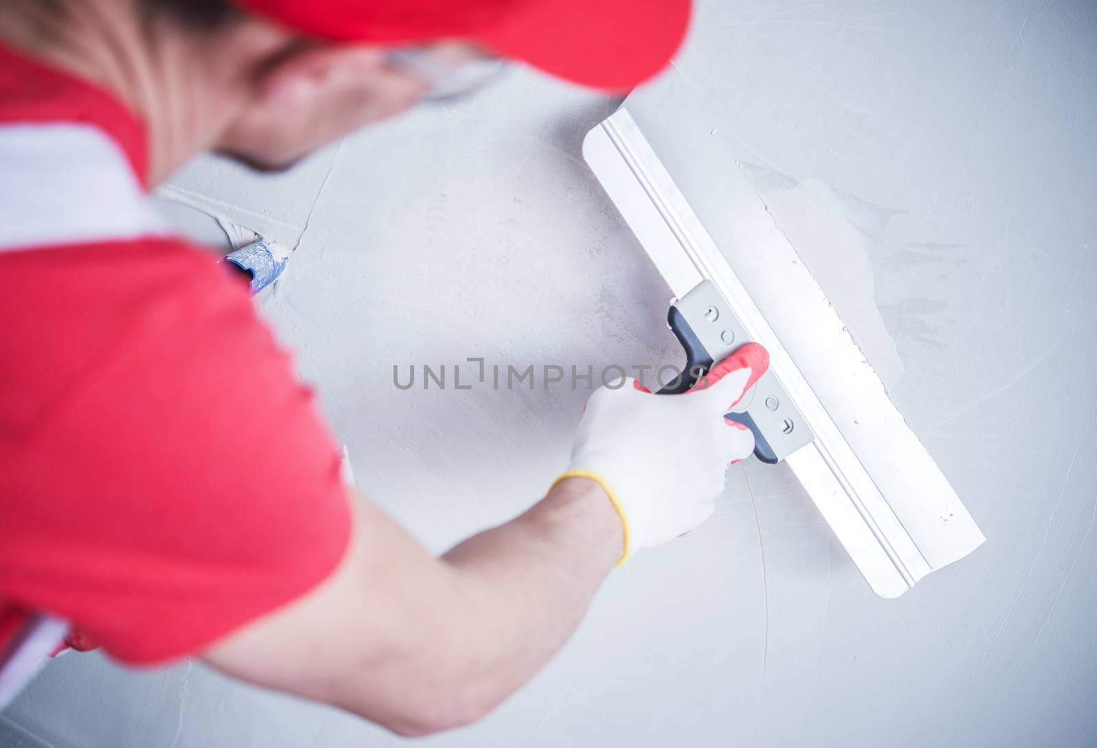 Drywall Patch by Construction Worker. Closeup Photo.