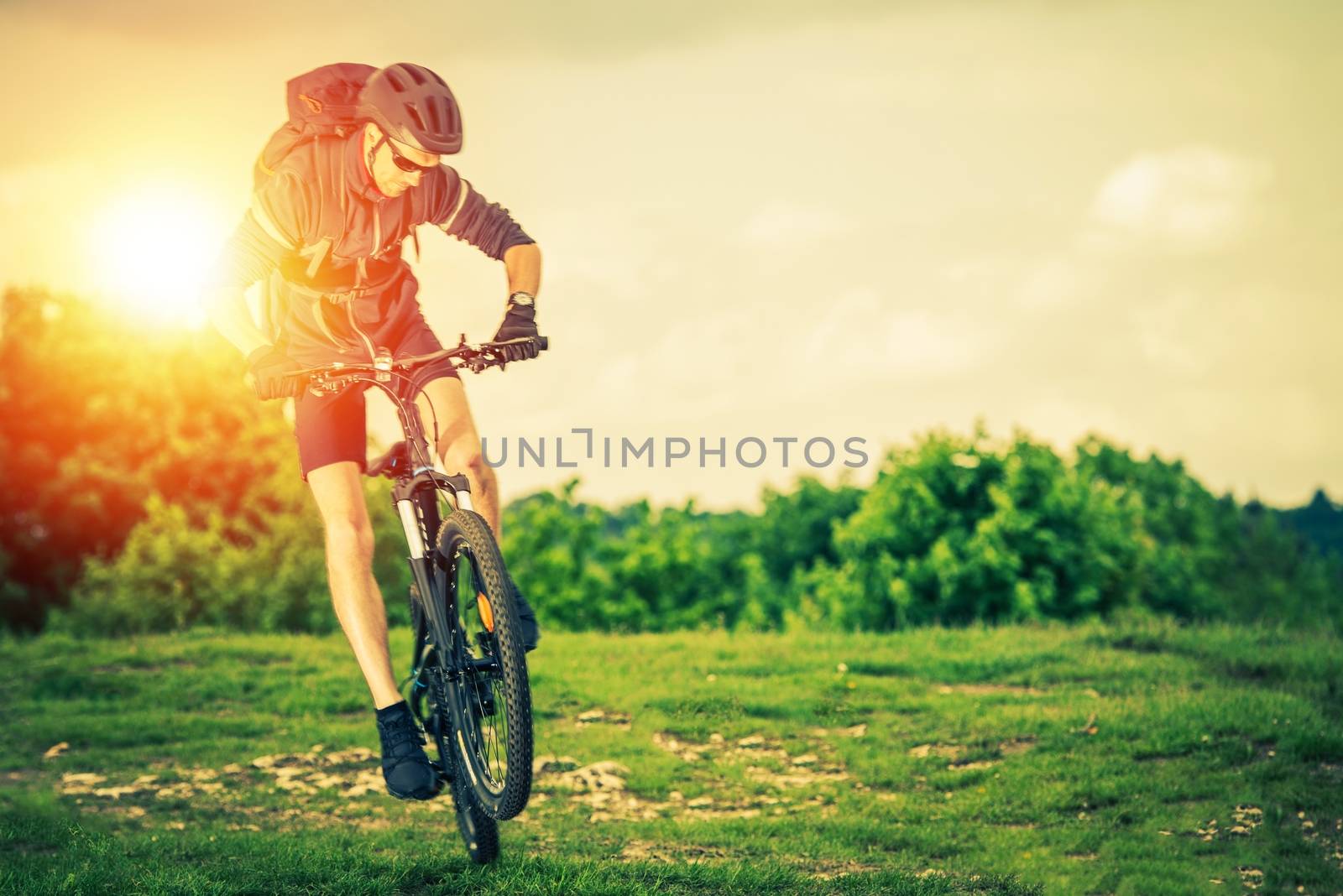 Extreme Mountain Biking. Summer Recreation and Sports Concept. Caucasian Biker.