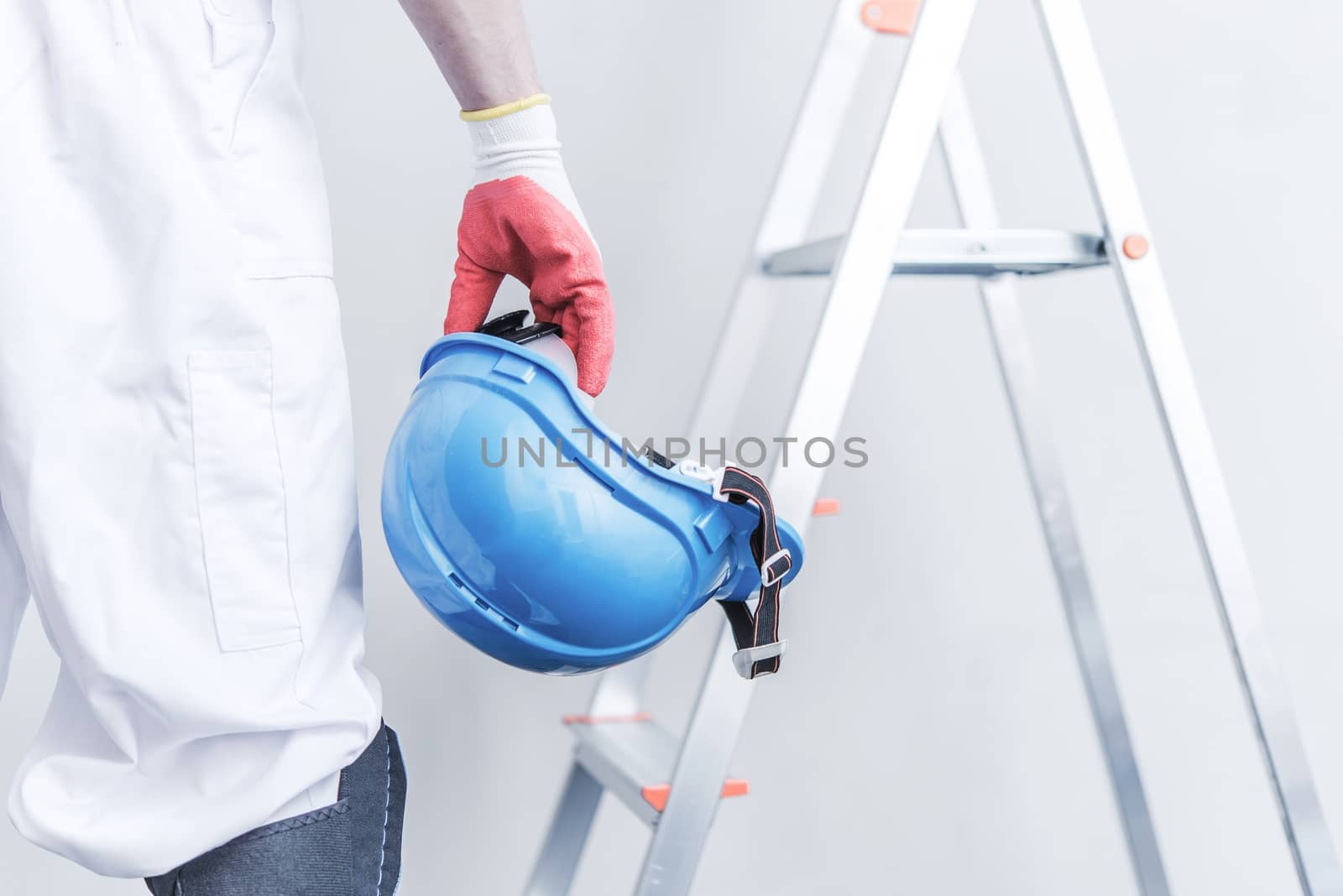 Hard Hat Construction Safety. Construction Worker with Construction Helmet in Hand.