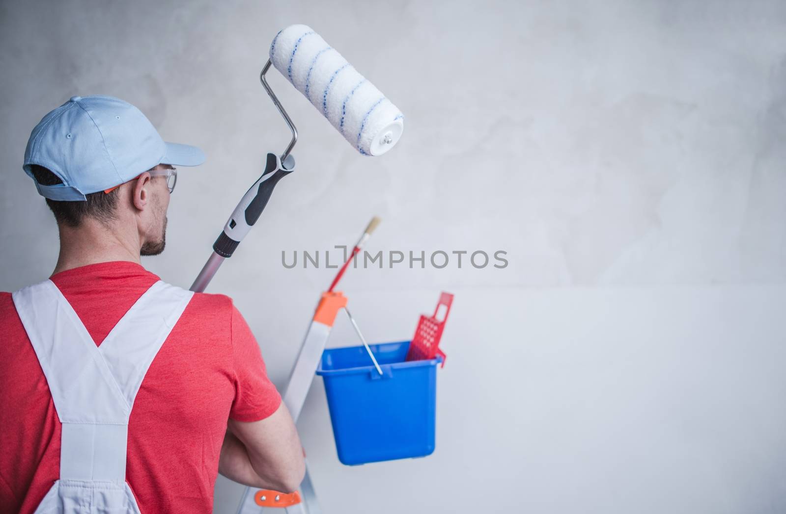 Interior Remodeling and Painting by Caucasian Remodeling and Construction Worker.