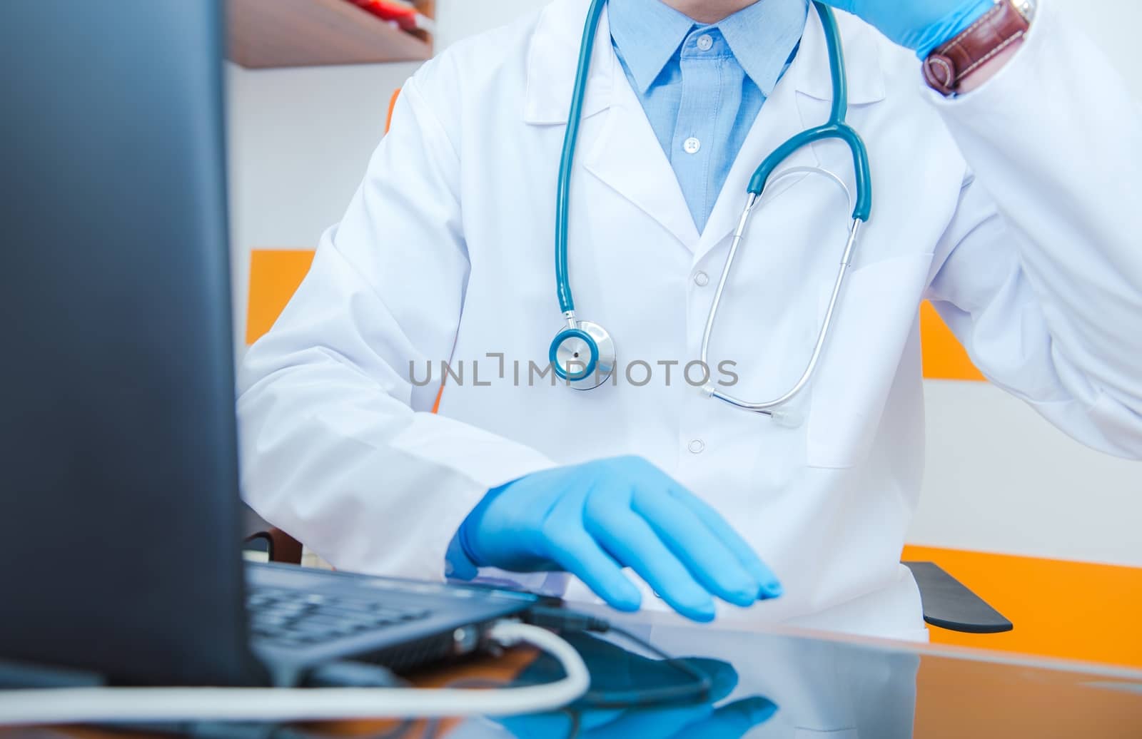 Medical Doctor and His Desk. Doctor Making Phone Call.