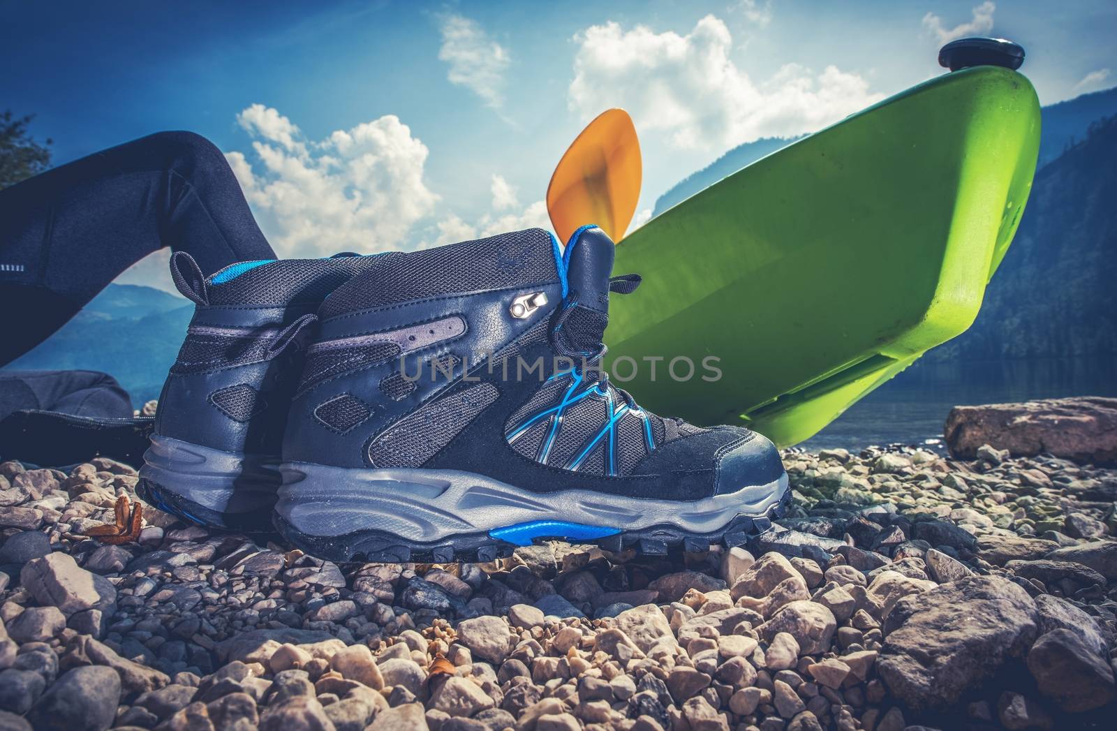 Outdoor Recreation Objects. Good Outdoor Hiking Shoes, Kayak and the Camping on the Edge of the Lake.