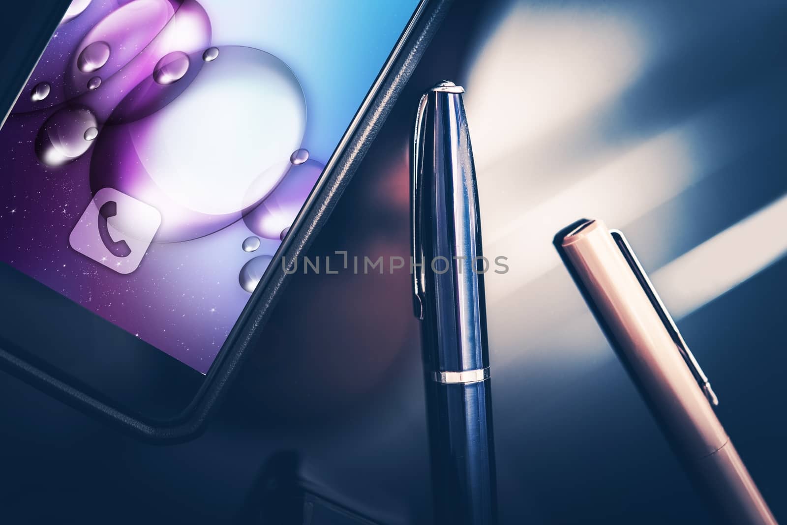 Smartphone in Business. Modern Desk Equipment and Tools. Smartphone and Elegant Pens on the Glassy CEO Desk. Closeup Photo.