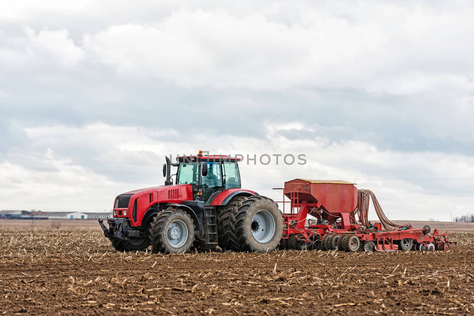 Farmer tractor working in the field. Spring time for sowing. Planting crops. 