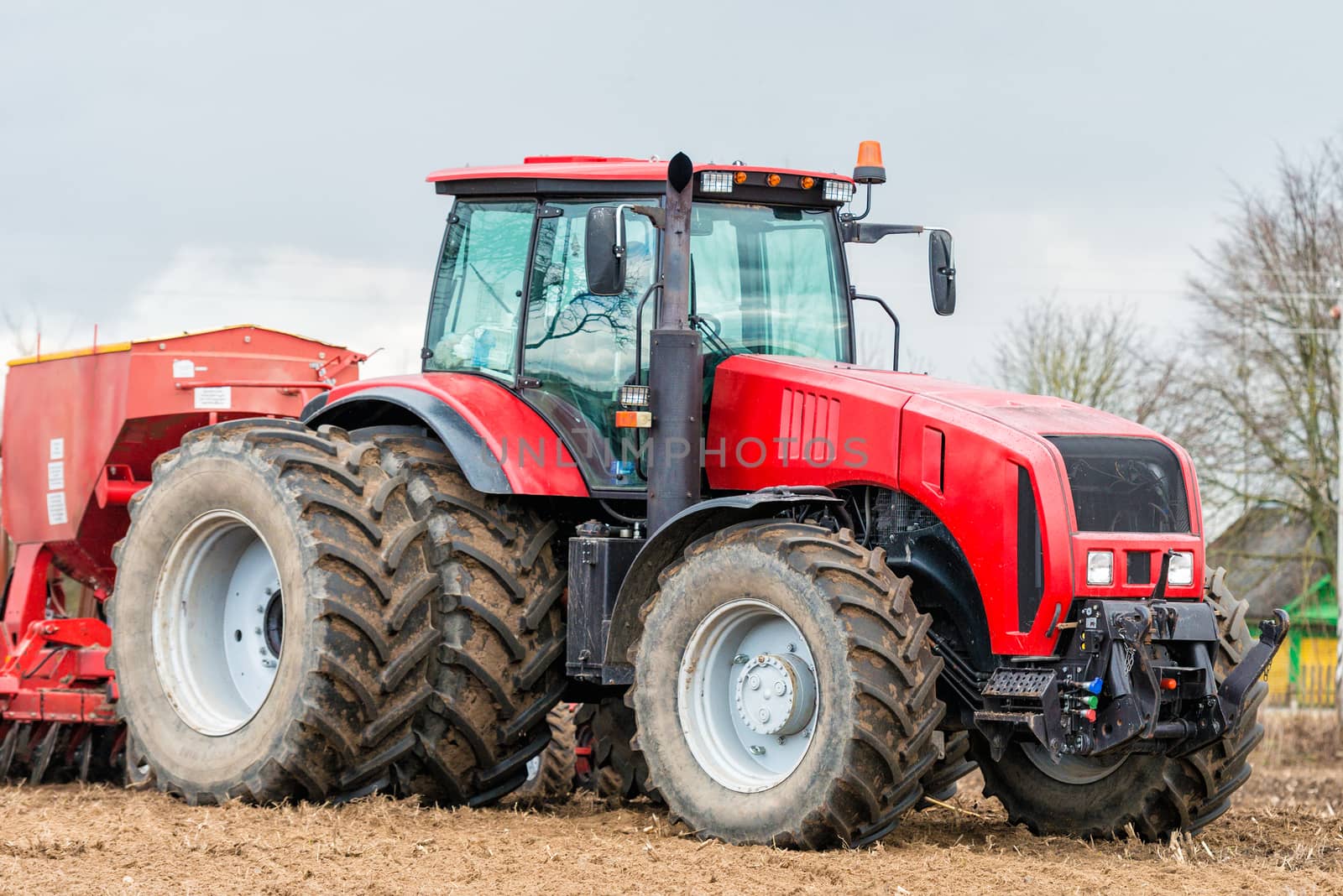 Farmer tractor working in the field. Spring time for sowing. Planting crops. 