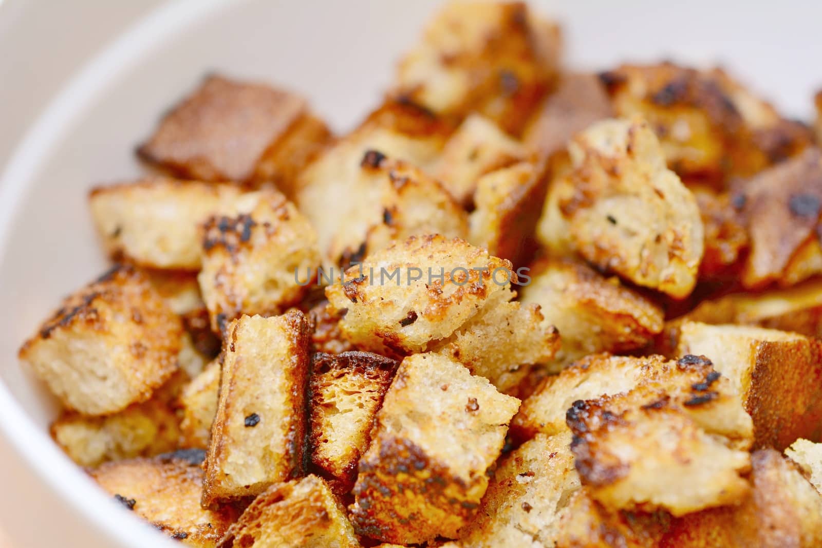 Closeup of Bread Croutons in White Bowl.