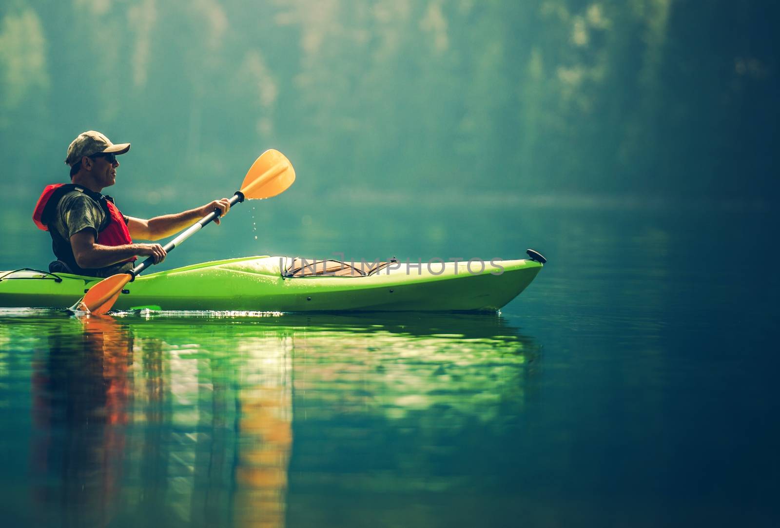 Senior Kayaker on the Lake. Kayak Paddling. Water Sport and Recreation.