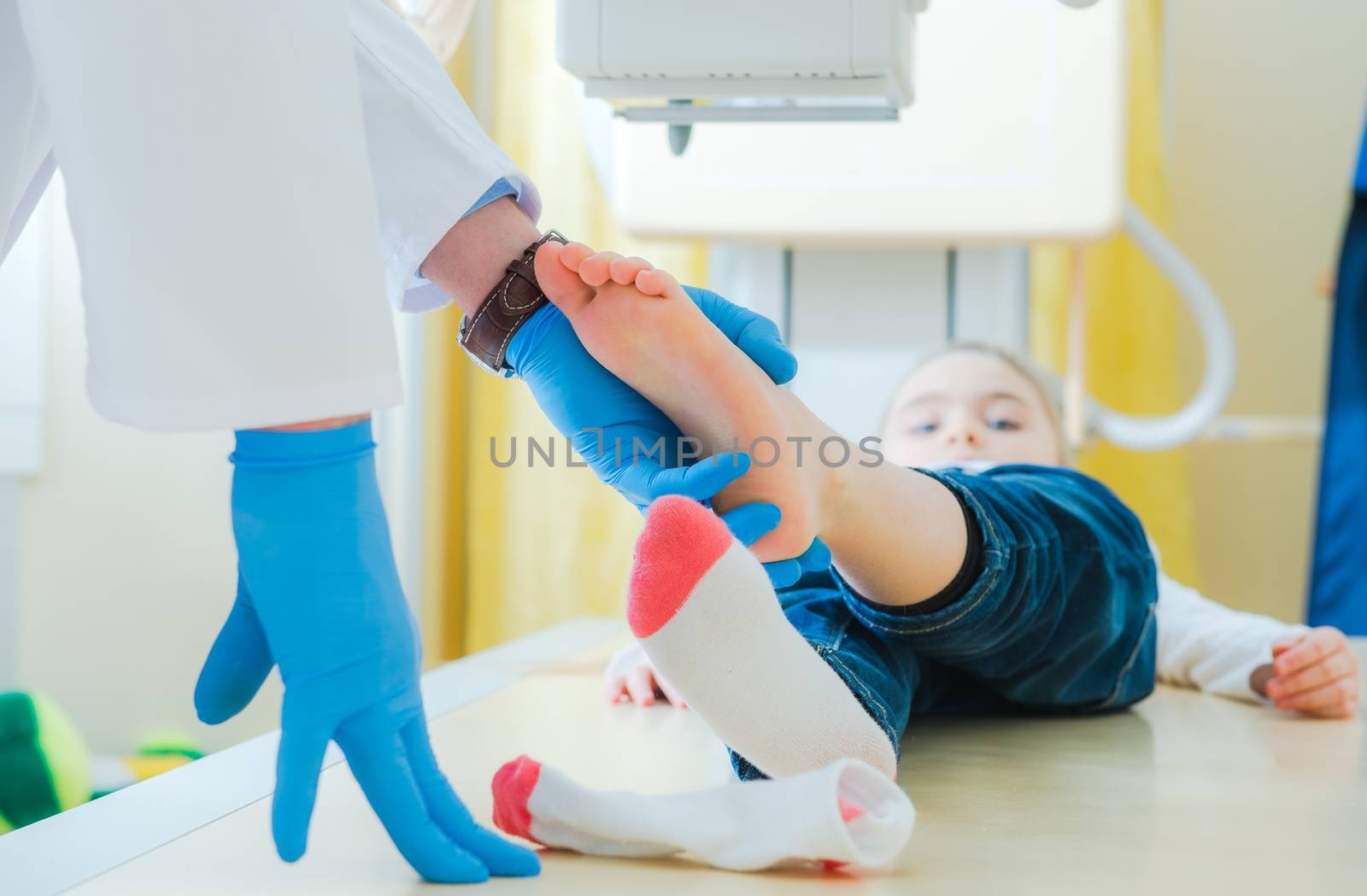 Broken Leg of Little Children X Ray Scanning. Radiology Imaging. Radiologist Preparing Girl for the Scan.