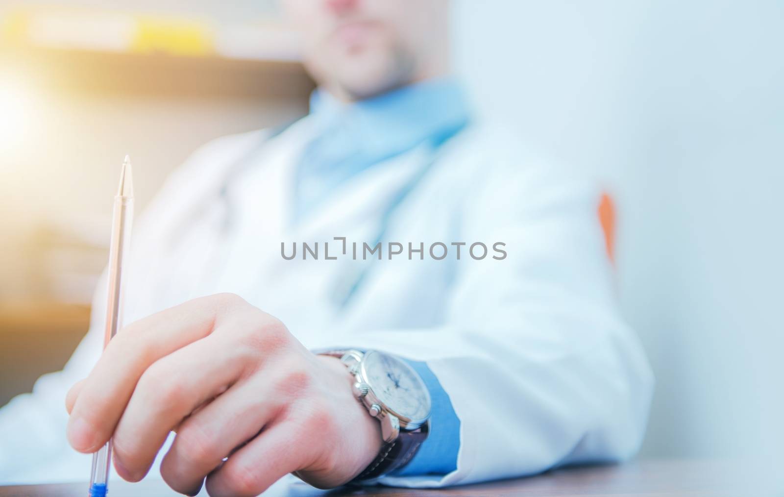 Confused Thinking Doctor Playing with His Pen While Seating in His Medical Office.