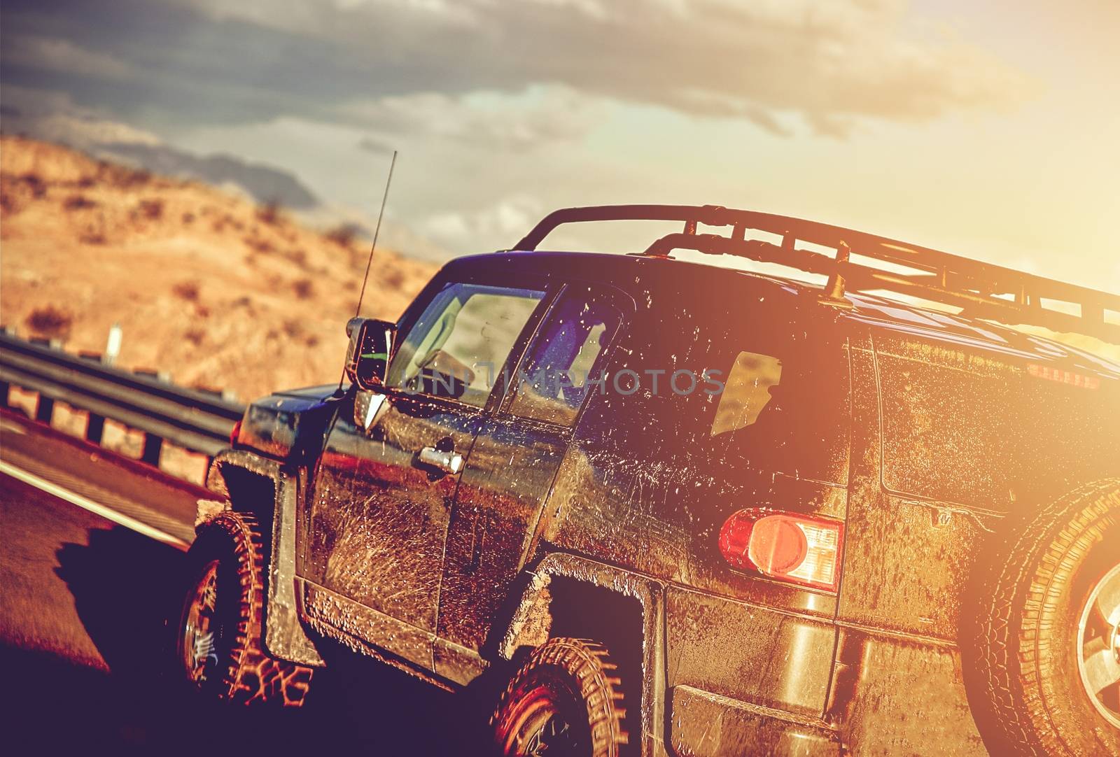 Dirty Off Road Trip. Dirty Full of Mud SUV Type Car Right After Crossing Wet Desert. 
