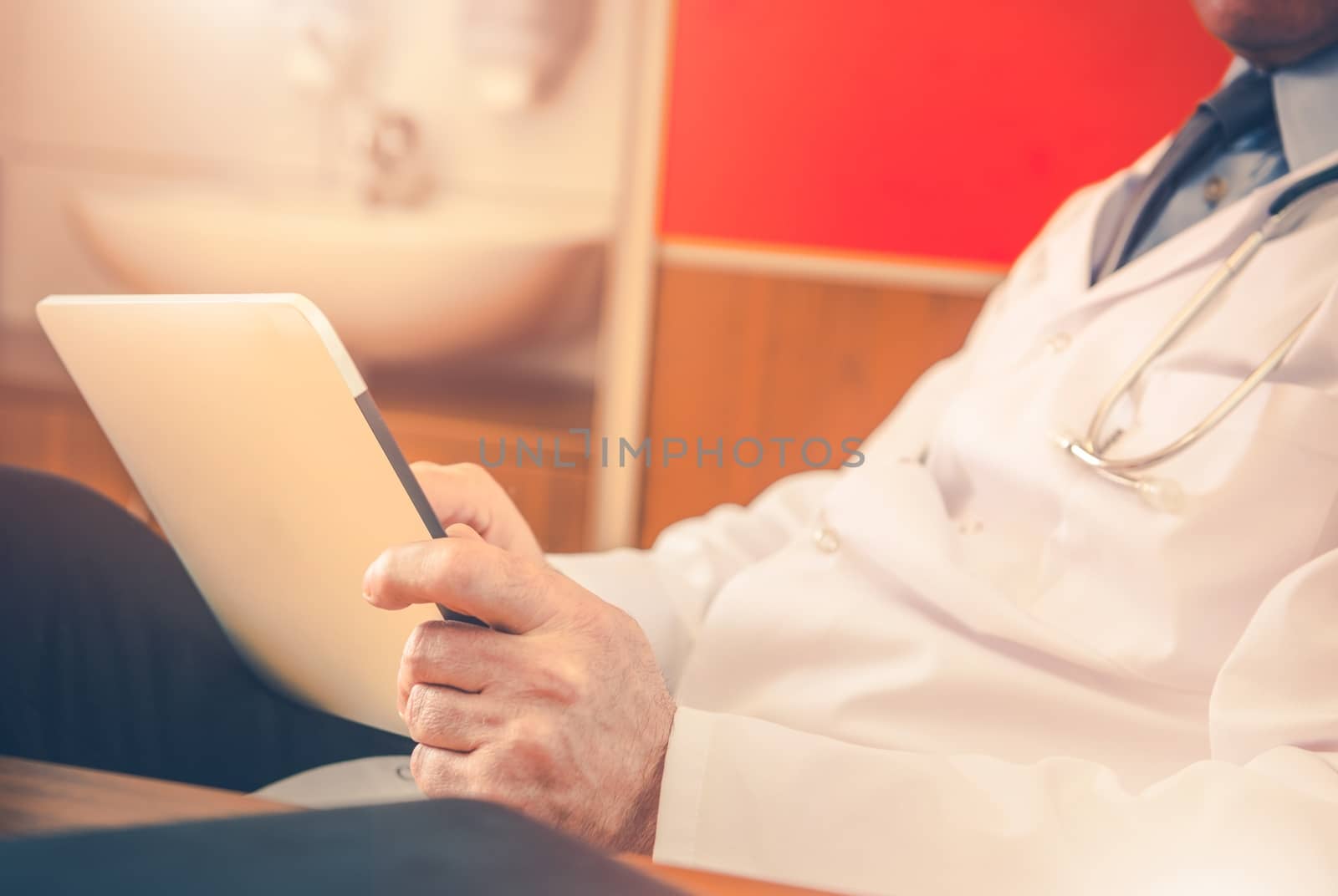 Doctor with Tablet Device Reading Science Research Magazine Online. 