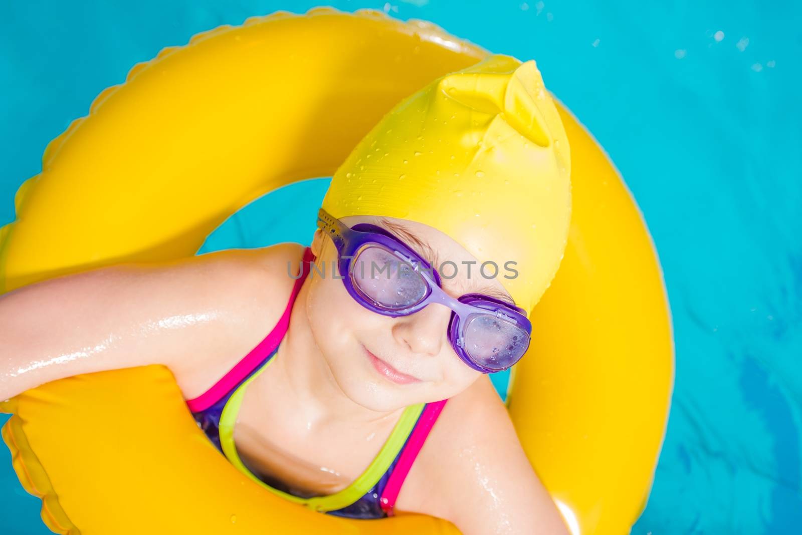 Little Caucasian Girl Learn to Swim in the Swimming Pool. Closeup Photo