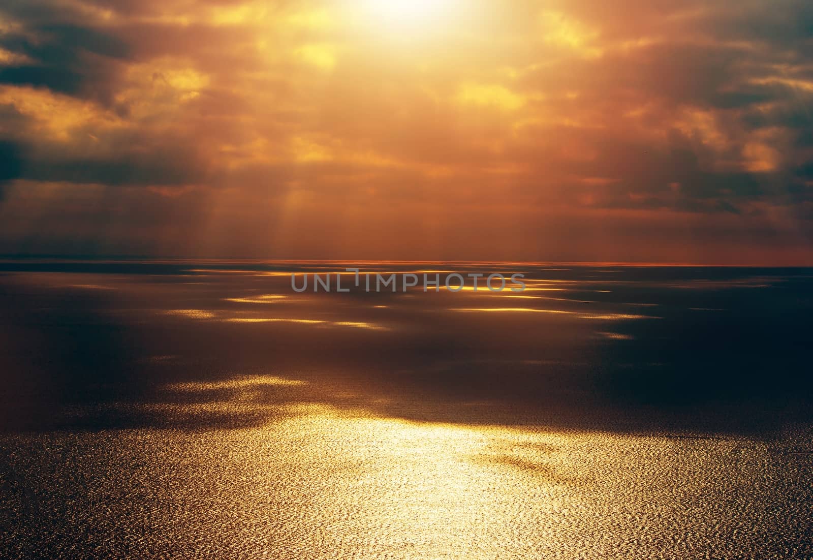Open Sea Sunset Scenery. Sunset Sun Rays and the Cloudy Sky. Beautiful Scenic Nature Photo.