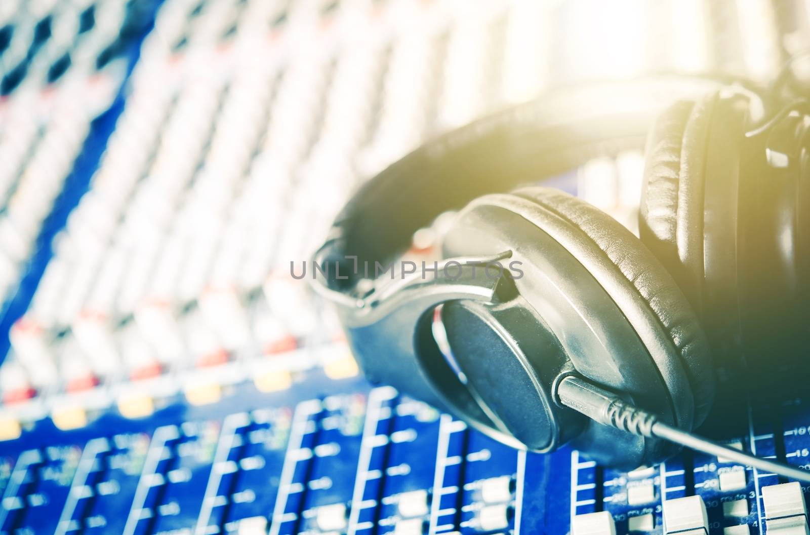 Recording Studio Headphones on the Audio Mixer Board. Closeup Photo. Music and Show Business Concept.