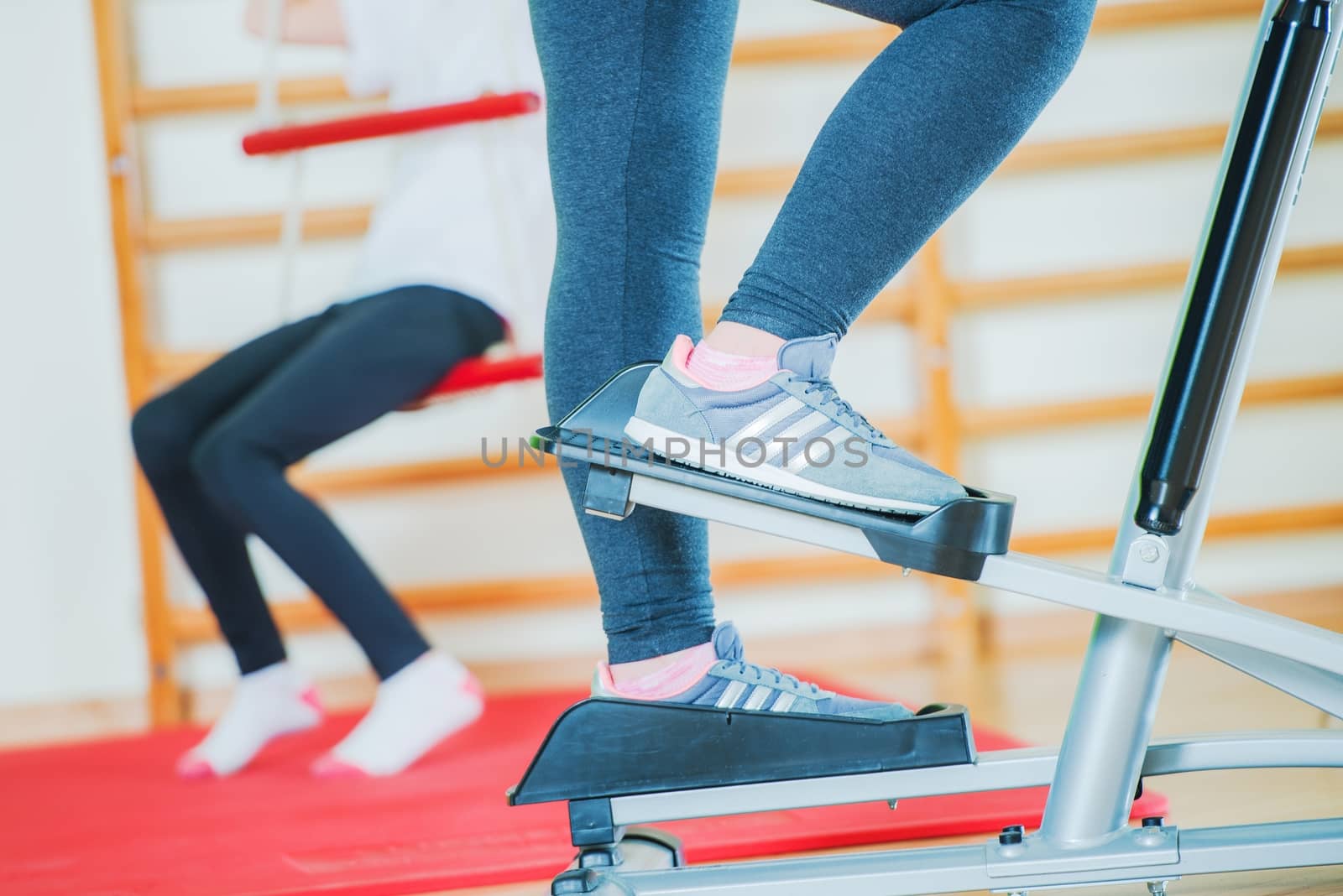 Stepper Workout Closeup. Woman on the Stepper in the Fitness Center.