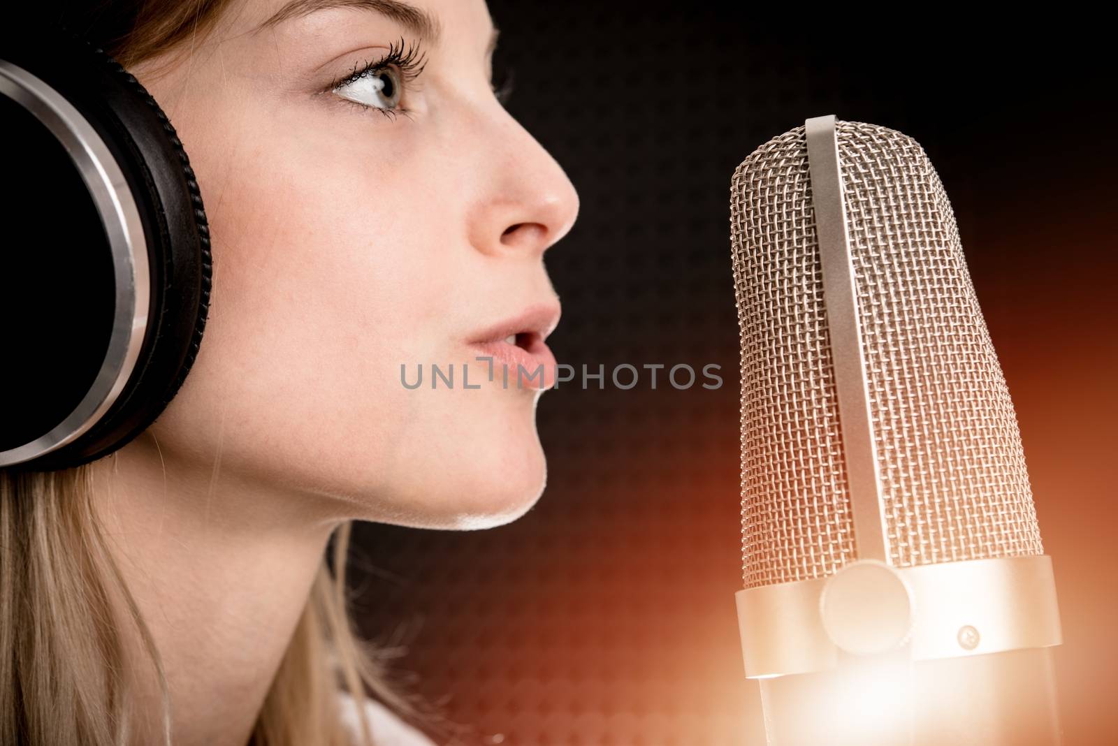 Voice Recording and Radio Concept. Young Caucasian Woman Recording Voice in the Studio.
