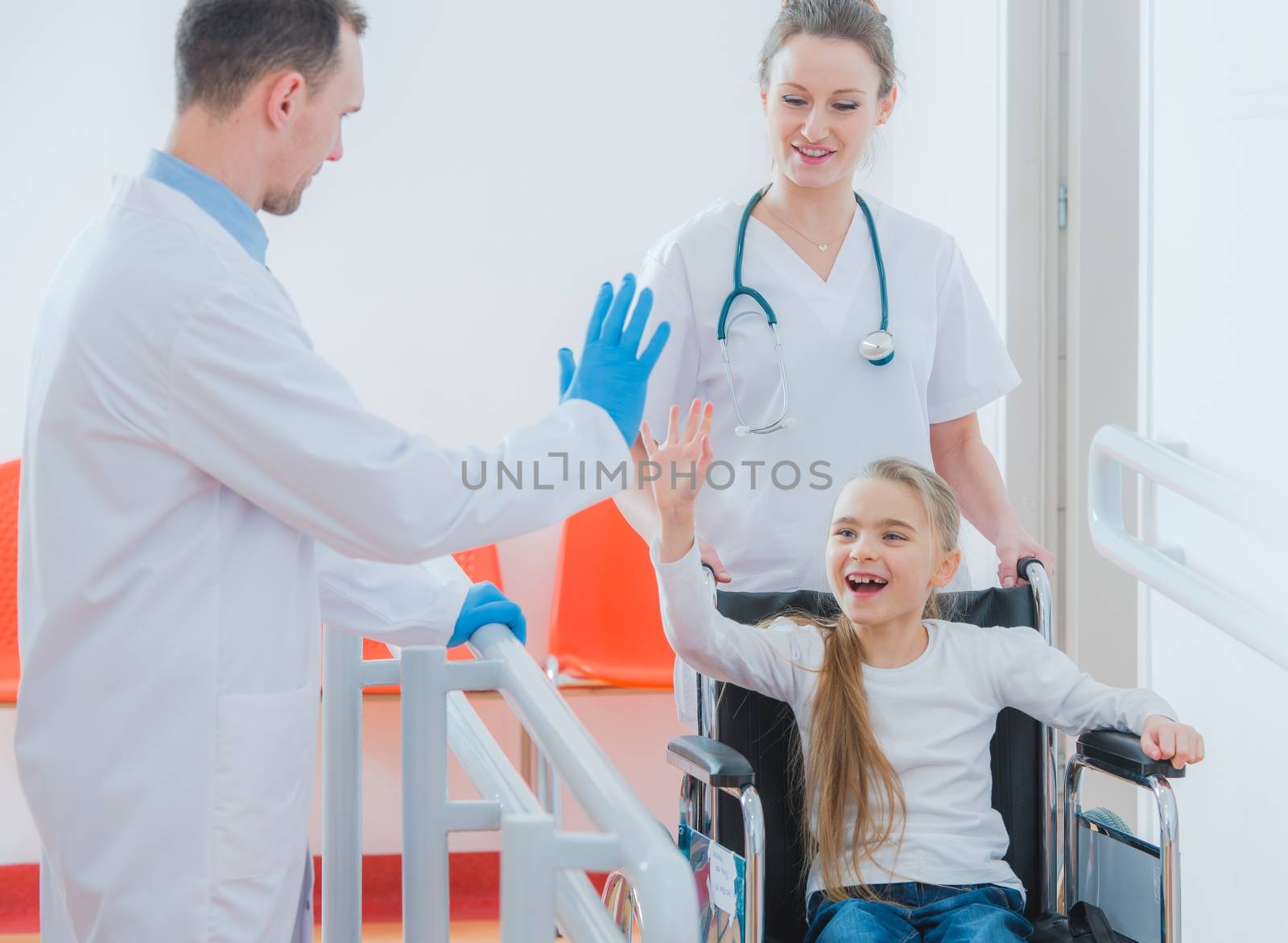 Happy Wheelchair Disabled Girl Giving High Five To Her Doctor. Mobility Impairments. 